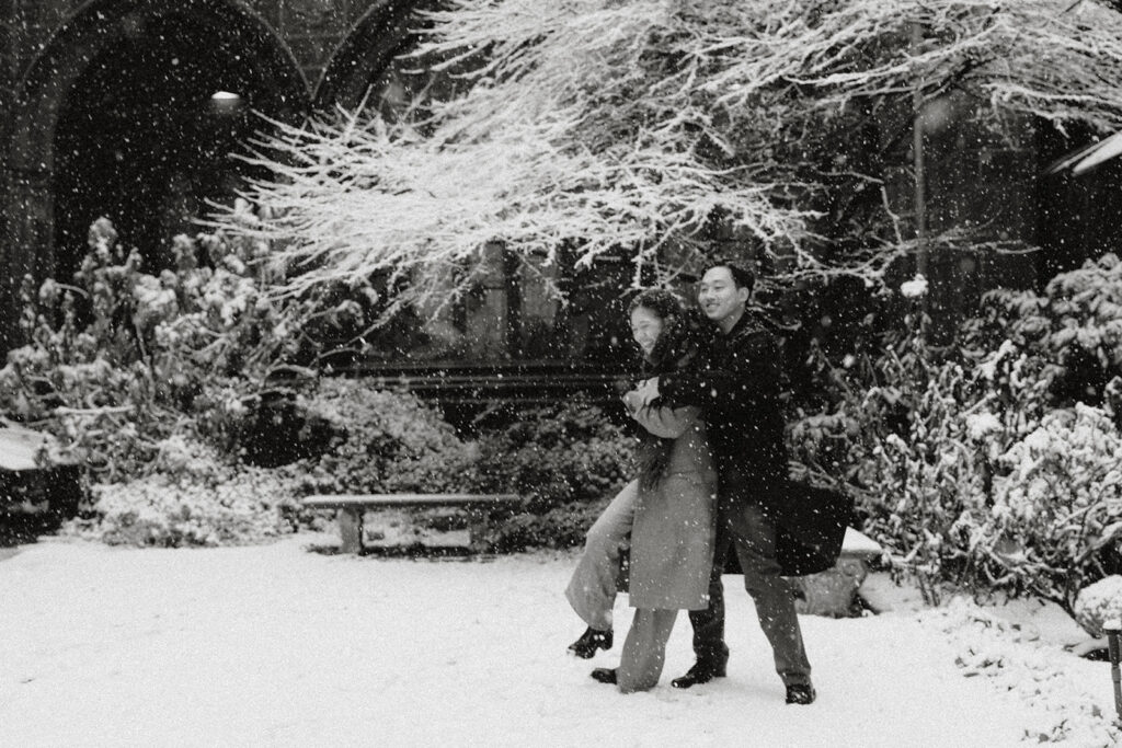Snowy engagement photos in New York City with a cinematic style.